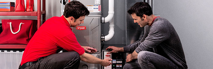 Bryant HVAC technician installing a new furnace